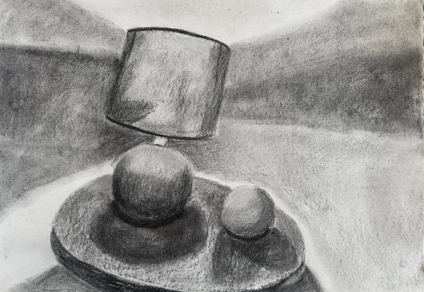 Charcoal still life of a lamp and two spheres on a table